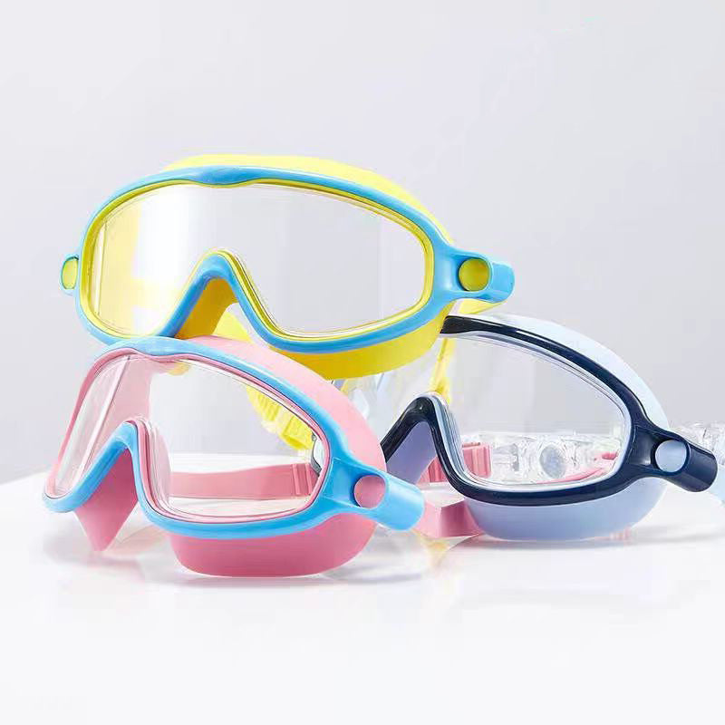 Three colorful swim goggles on a light gray background