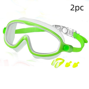 Green and white swim goggles with earplugs on a white background