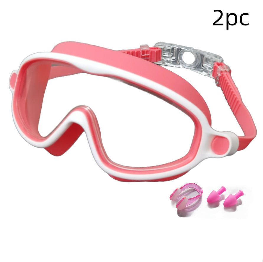 Pink and white swim mask with two pink earplugs on a white background