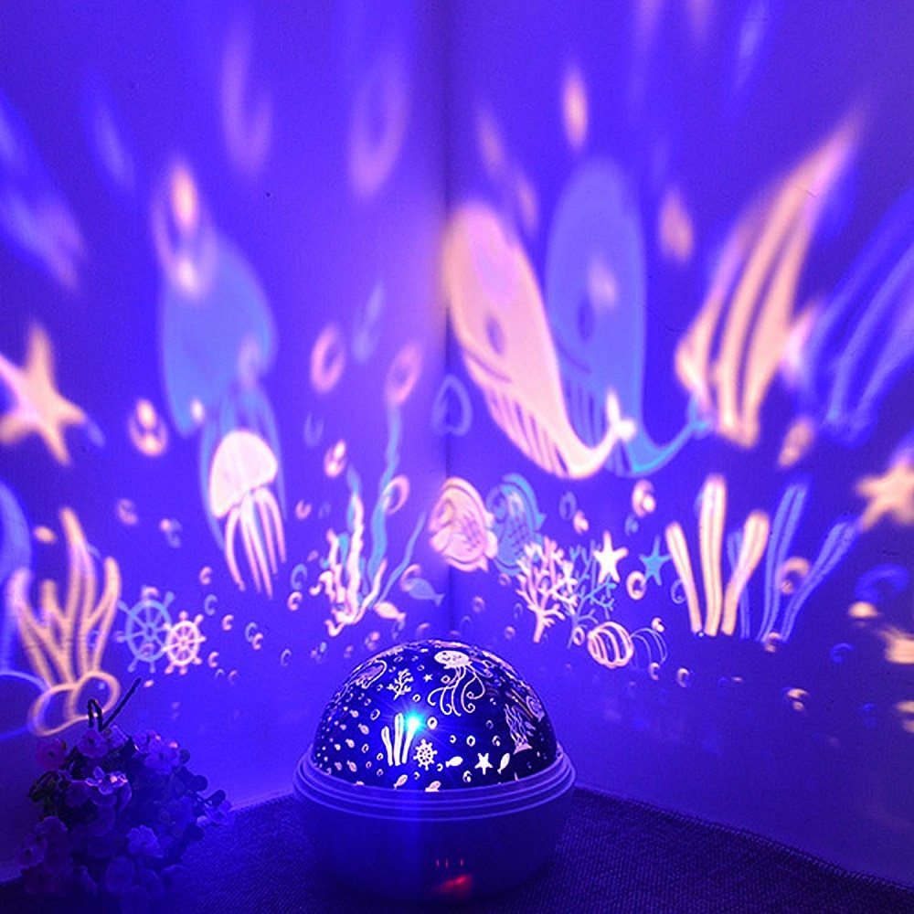 Underwater-themed night light projector with colorful projections on a dark background