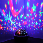 Colorful star and moon projector on a dark background