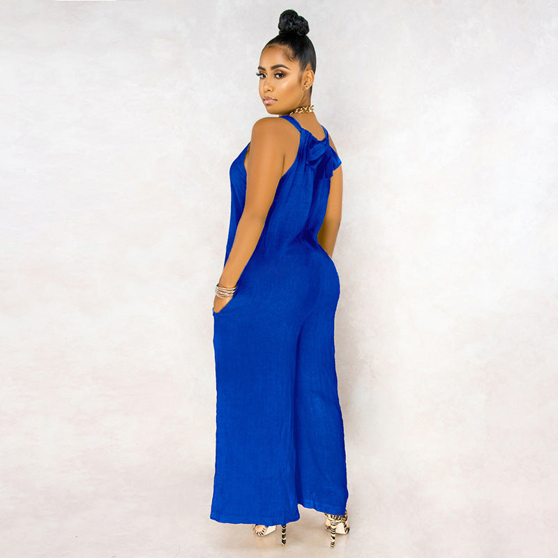 Woman wearing a blue jumpsuit against a white background