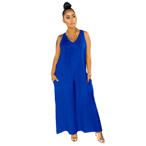 Woman wearing a blue sleeveless jumpsuit on a white background