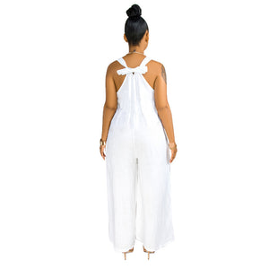 Woman wearing a white halter neck jumpsuit on a white background