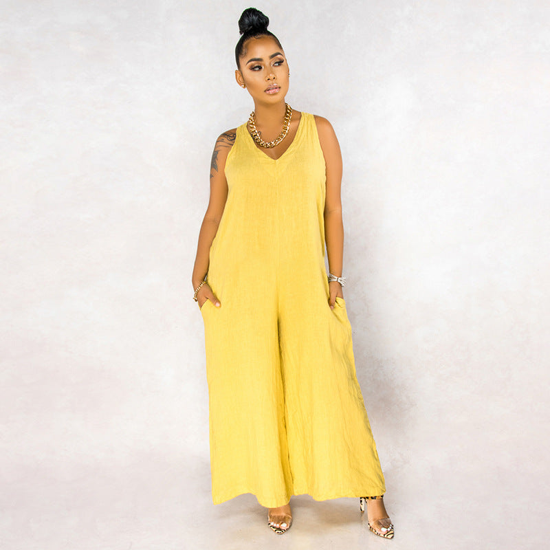 Woman wearing a yellow sleeveless jumpsuit against a white background