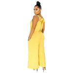 Woman wearing a yellow jumpsuit on a white background