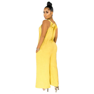 Woman wearing a yellow jumpsuit on a white background
