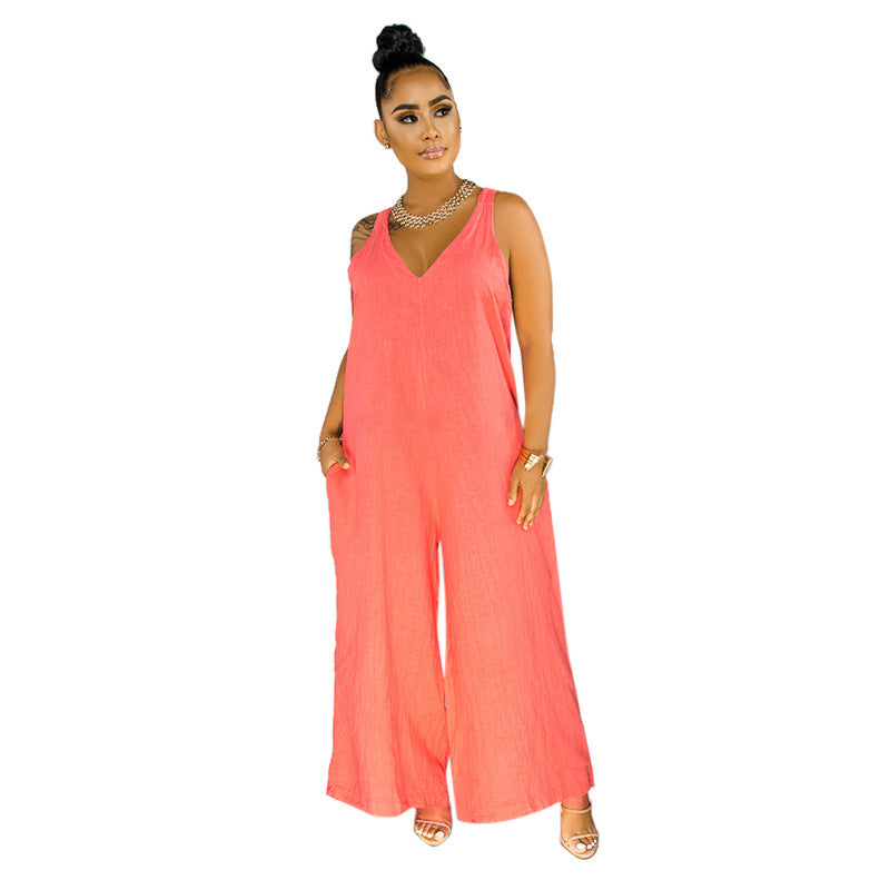 Woman wearing a coral jumpsuit on a white background