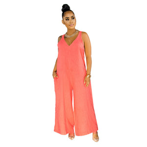 Woman wearing a coral jumpsuit on a white background