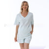 Woman wearing a light blue outfit on a white background