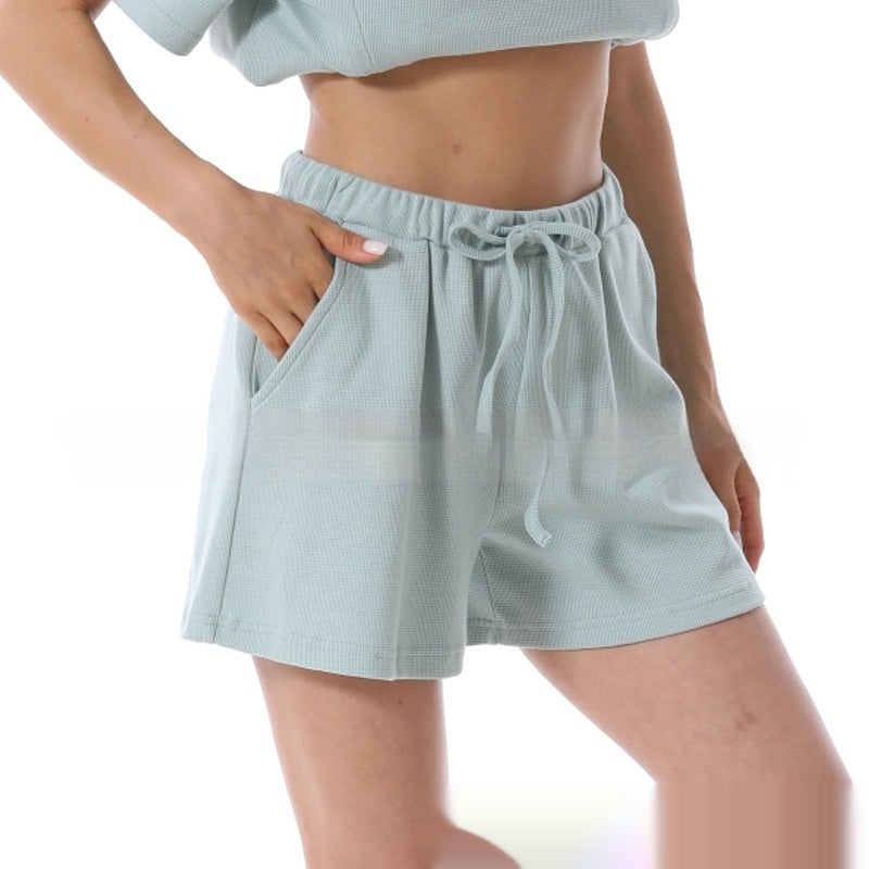 Light blue shorts worn by a person on a white background