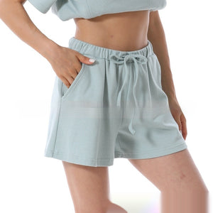 Light blue shorts worn by a person on a white background
