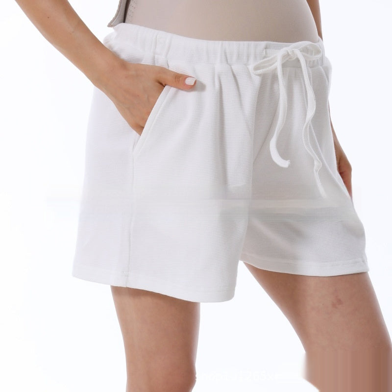 White shorts worn by a person on a white background