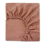Brown textured fitted sheet on a white background