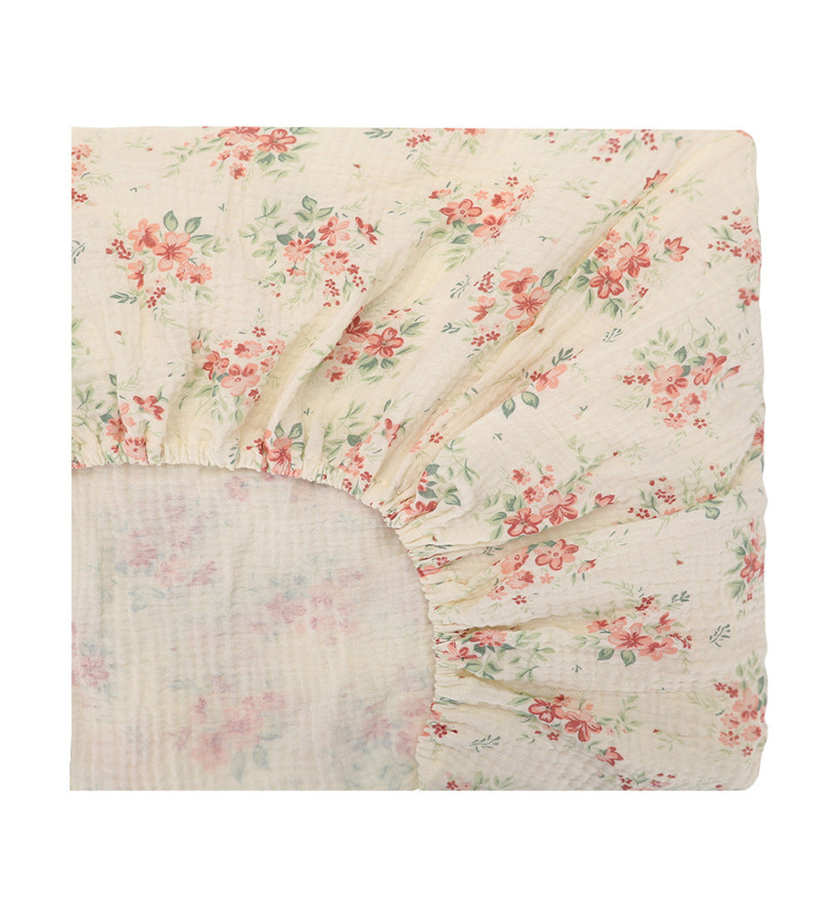 Floral patterned quilt on a white background