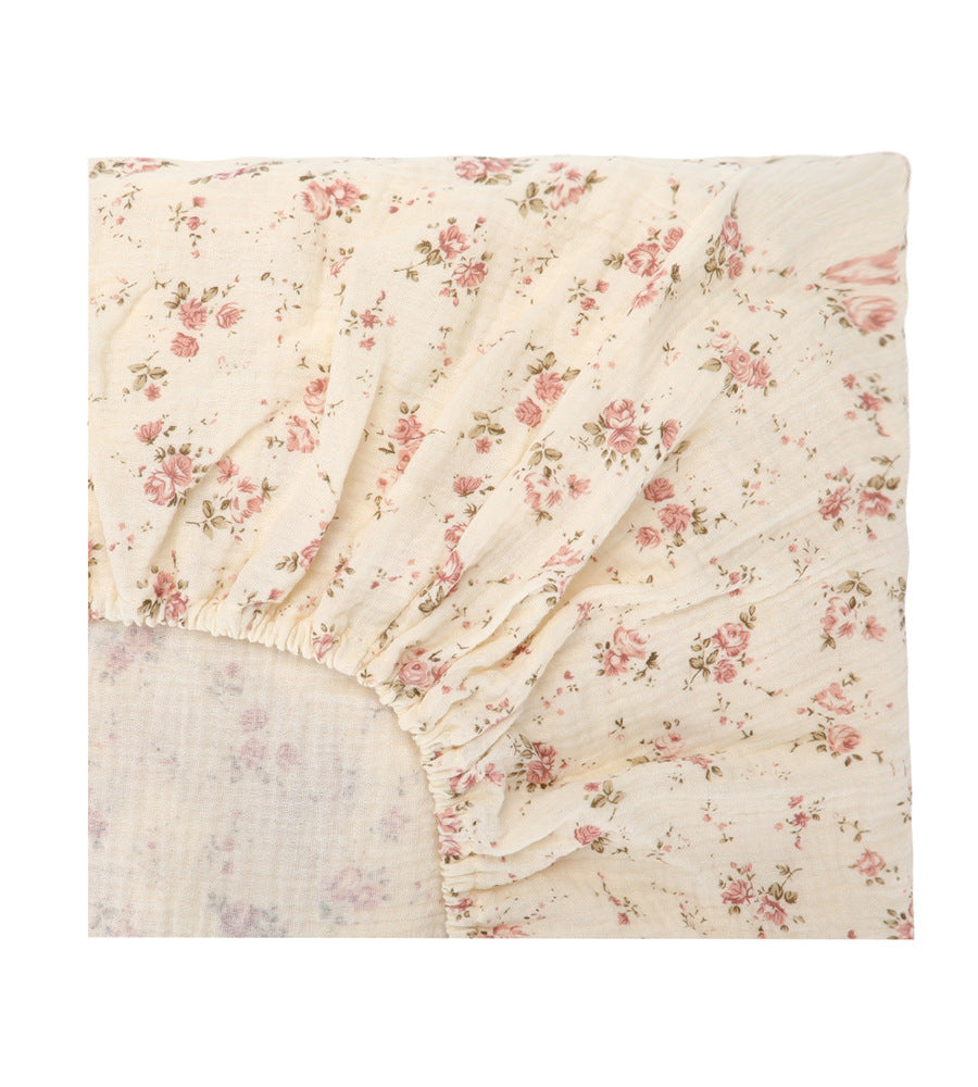 Floral patterned fitted sheet on a white background