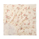 Floral patterned fitted sheet on a white background