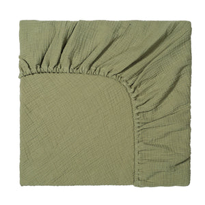 Green fabric with a textured pattern on a white background