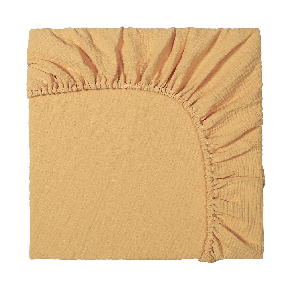 Mustard yellow fitted sheet on a white background