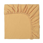 Mustard yellow fitted sheet on a white background