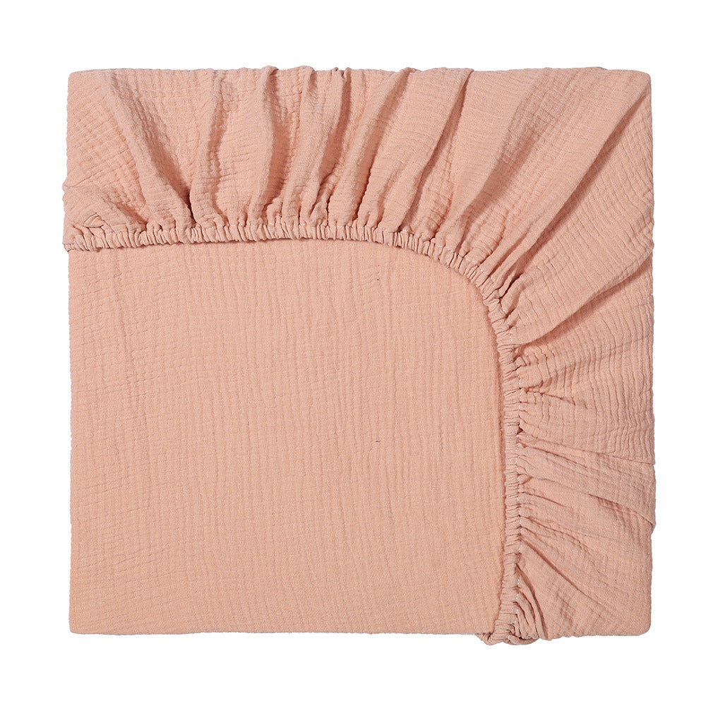 Pink fitted sheet on a white background