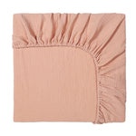 Pink fitted sheet on a white background