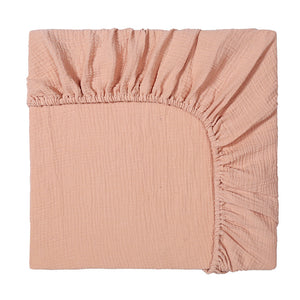 Pink fitted sheet on a white background