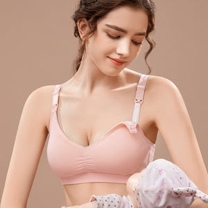 Woman wearing a pink bra with a neutral background