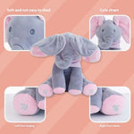 Gray elephant plush toy with pink accents on a peach background