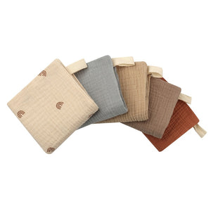 Set of five fabric cushions in beige, gray, brown, and rust colors on a white background.