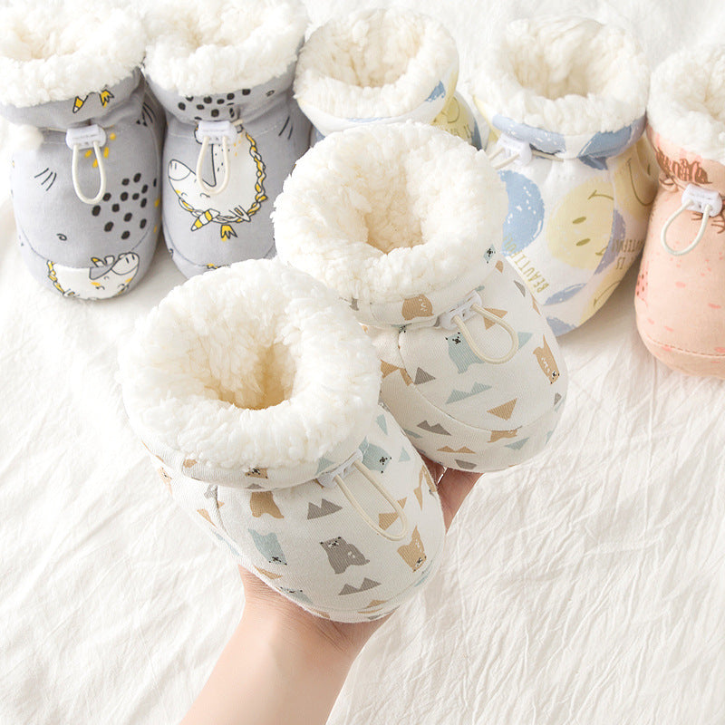 Baby booties with soft interior and patterned exterior on a white background