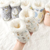 Baby booties with soft interior and patterned exterior on a white background