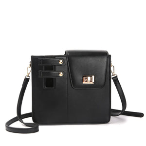 Black crossbody bag with gold accents on a white background