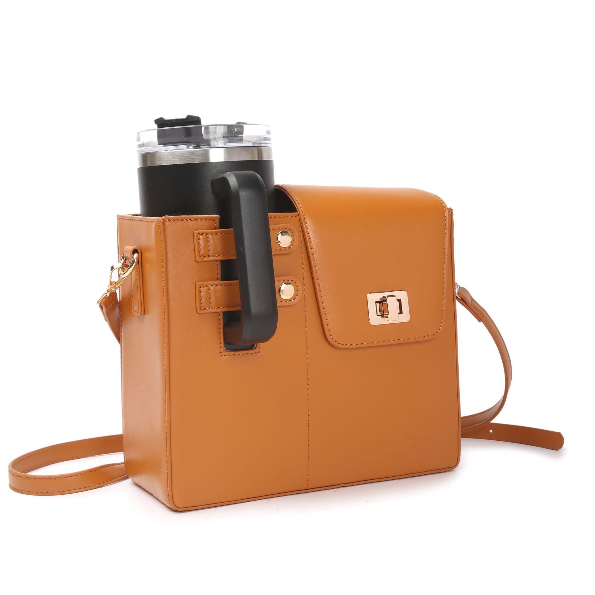 Brown leather crossbody bag with a black handle holding a tumbler on a white background