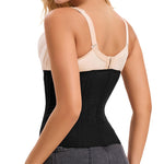 Woman wearing a black waist trainer with beige bra on a white background