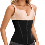 Woman wearing a black waist trainer over a beige tank top on a white background