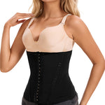 Woman wearing a black waist trainer over a beige top on a white background