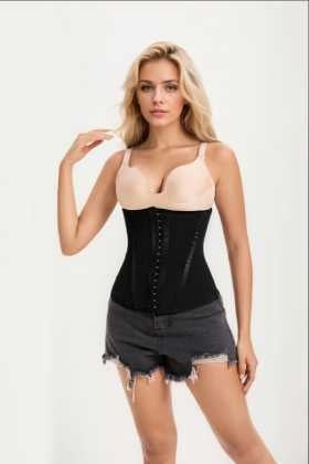 Woman wearing a black corset and denim shorts on a white background