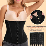 Woman wearing a black waist trainer with a beige top, on a beige background.
