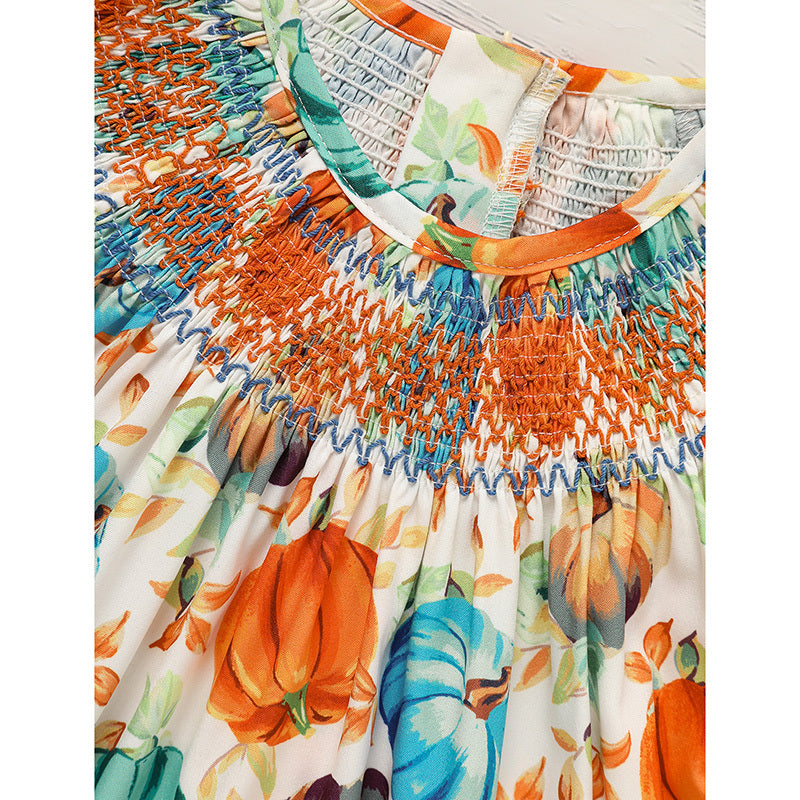 Colorful dress with pumpkin and leaf pattern on a white background