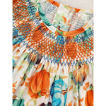 Colorful dress with pumpkin and leaf pattern on a white background