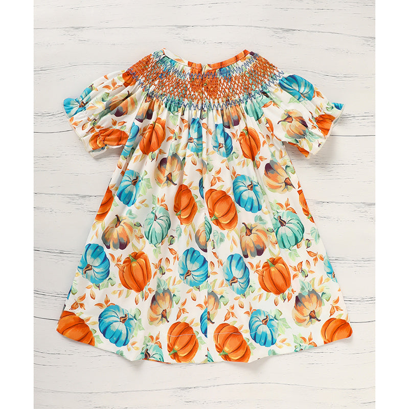 Dress with pumpkin pattern on a wooden surface