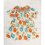 Dress with pumpkin pattern on a wooden surface