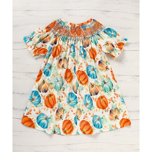 Dress with pumpkin pattern on a wooden surface