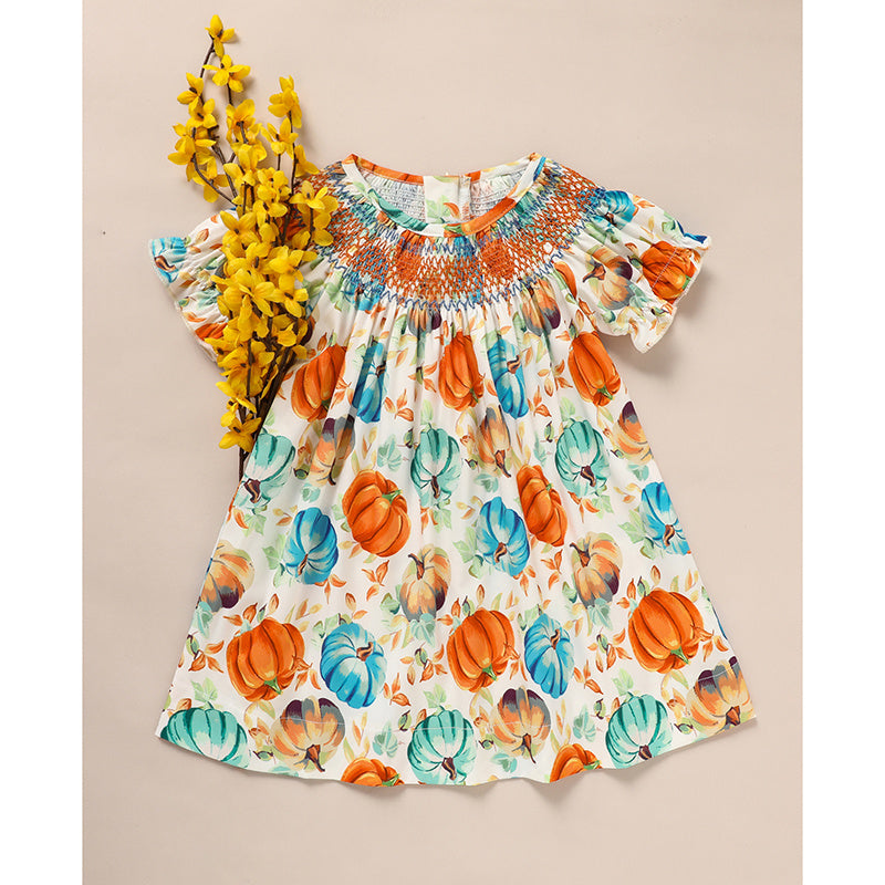 Colorful dress with pumpkin pattern on a beige background
