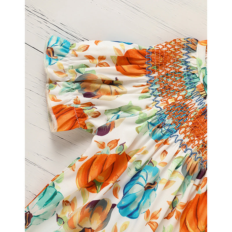 Colorful fabric with pumpkin pattern on a wooden surface