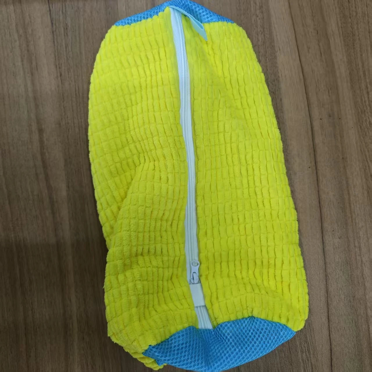 Yellow and blue textured mat on a wooden floor
