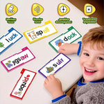 Child playing with educational flashcards on a table, surrounded by various flashcards with letters and words.