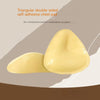Triangular double-sided self-adhesive chest pad on a beige background