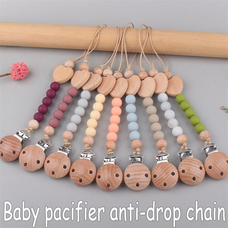 Colorful baby pacifier anti-drop chain with wooden beads on a gray background